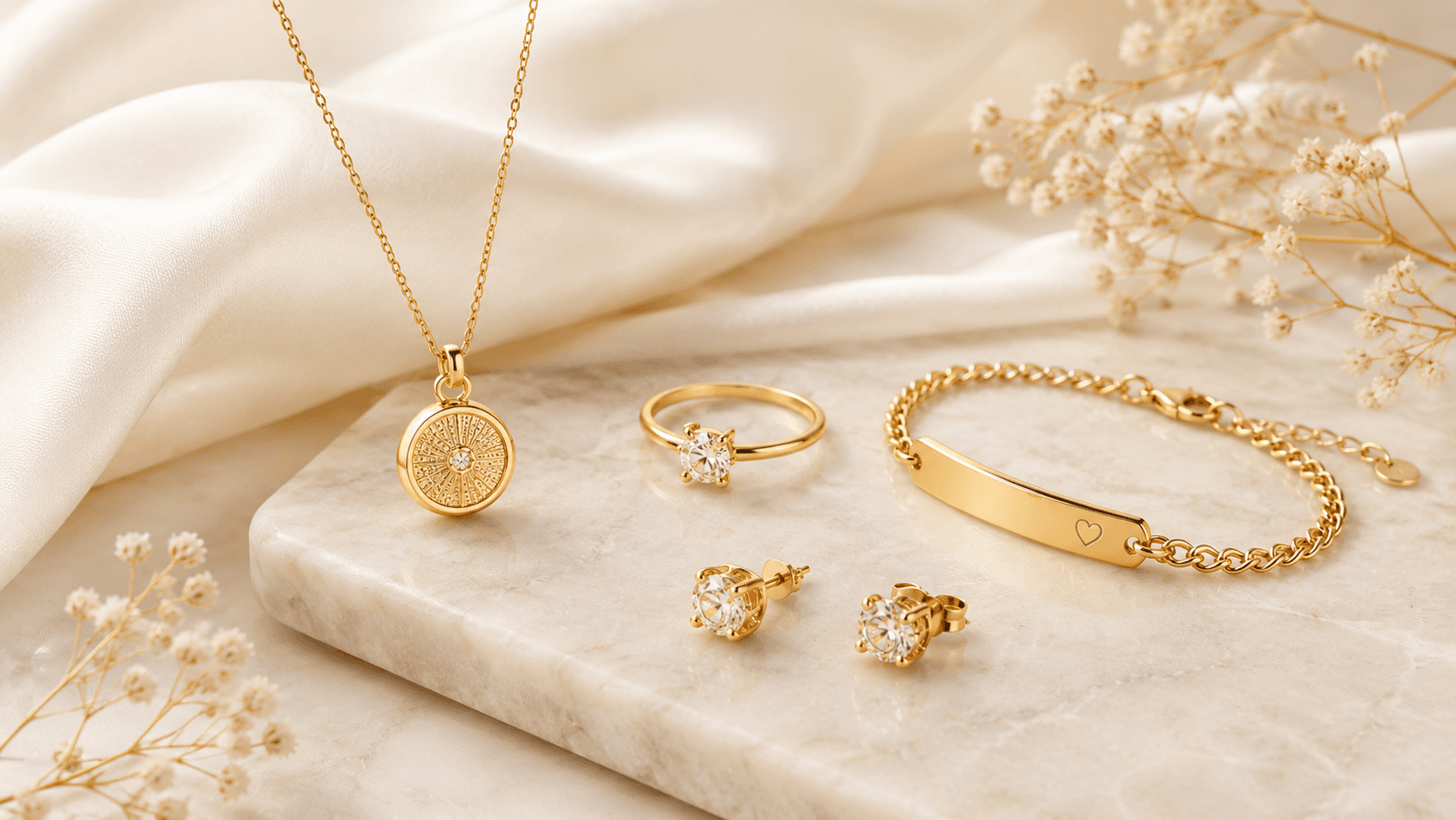 Elegant gold jewelry with necklace, ring, bracelet and earrings on light marble